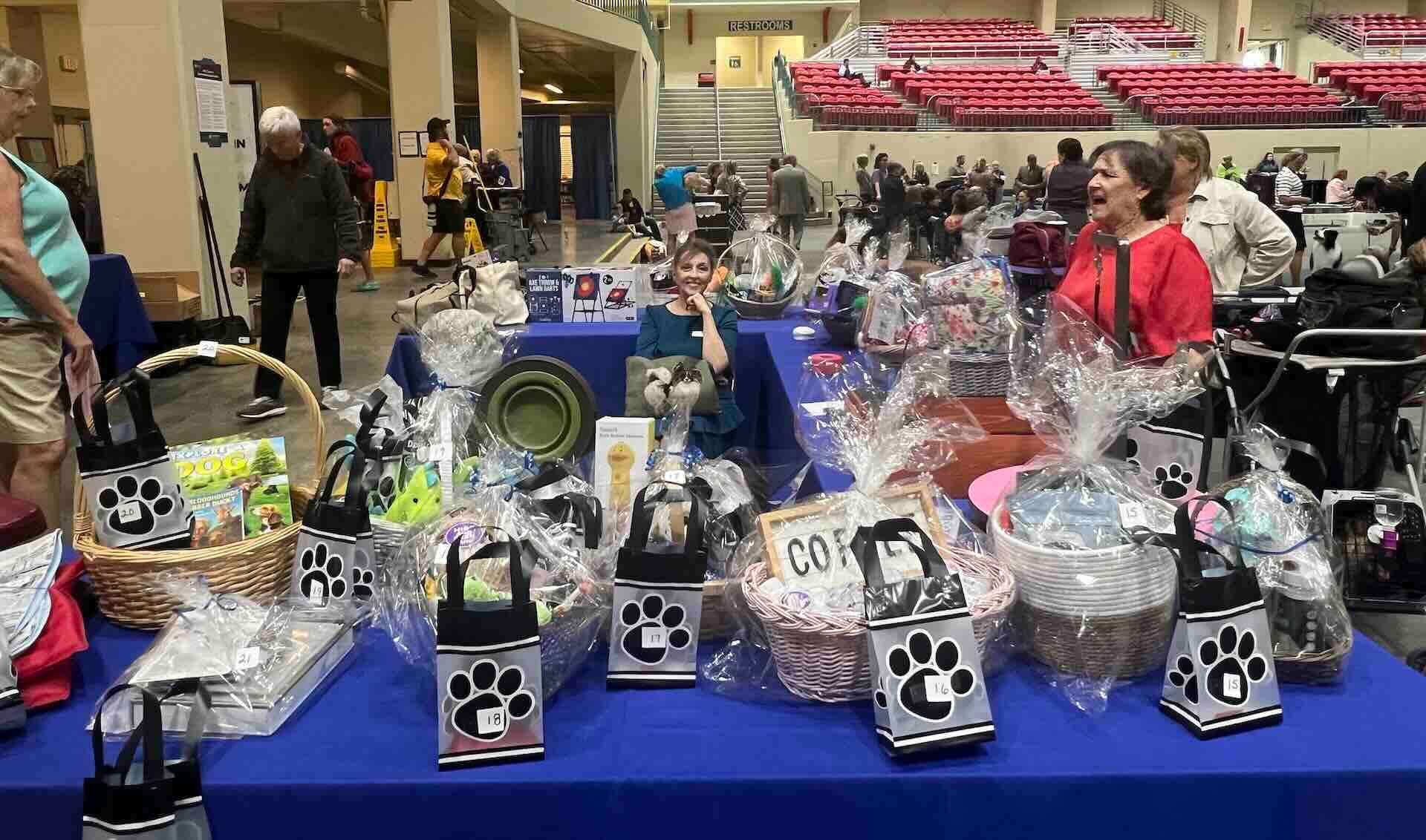 Silent auction table with gift baskets indoors